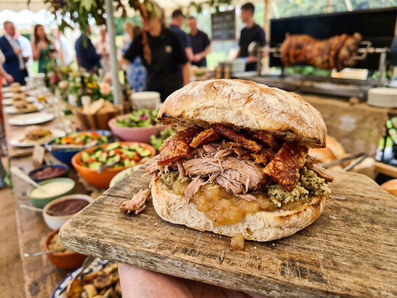 Slow roasted pig on a spit pork in a bap The Whole Hog catering Ireland